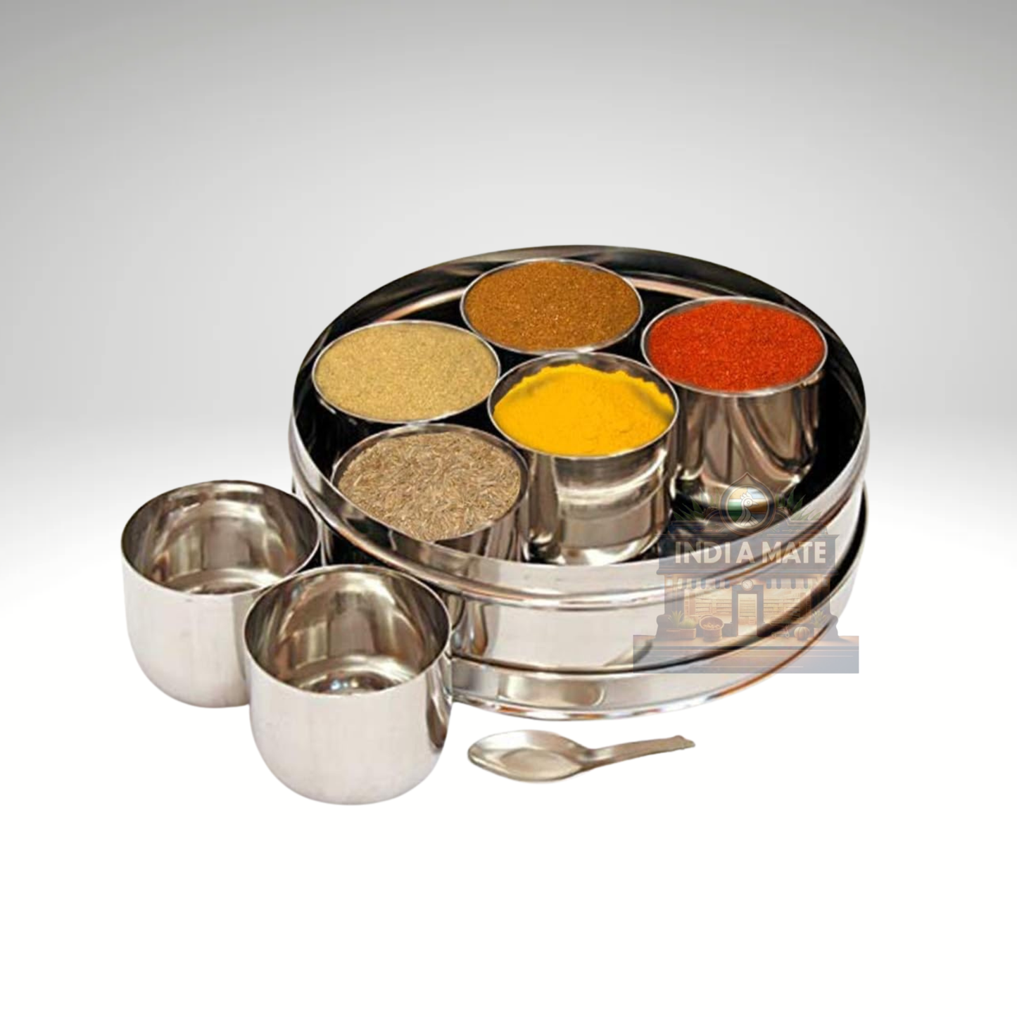 Set of metal spice containers with spices on a white background