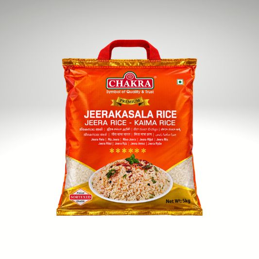 A 5kg bag of Chakra Premium Jeerakasala Rice (Jeera Rice - Kaima Rice) on a light gray gradient background. The packaging is bright orange with a red handle, featuring the Chakra brand logo and a picture of the prepared rice dish.