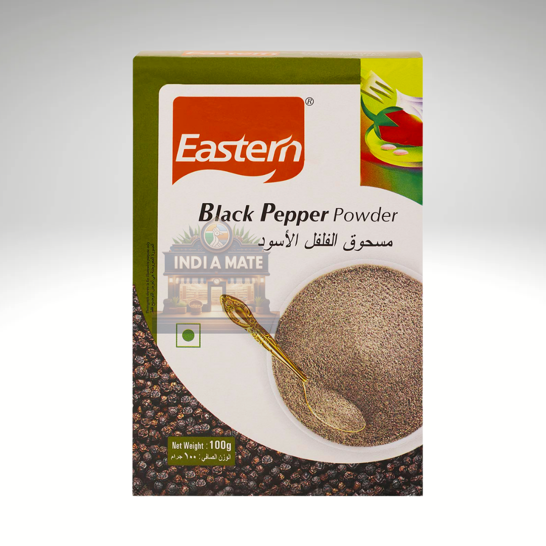 Box of Eastern Black Pepper Powder with a spoon and pepper on a white background