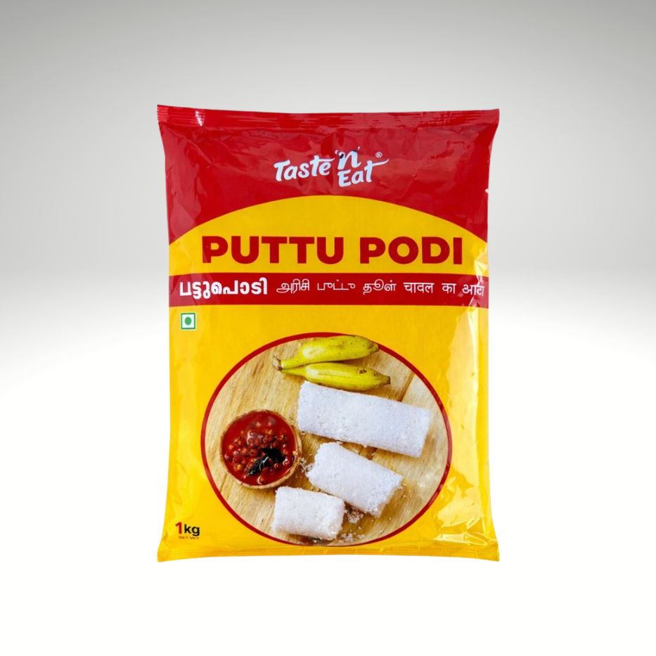 A 1 kg package of Taste 'n Eat Puttu Podi, featuring a red and yellow packaging design with a circular image of prepared puttu podi rolls.