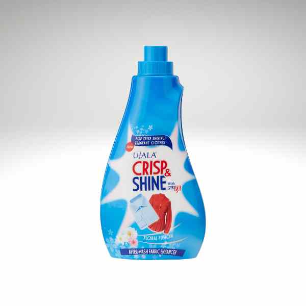 A bottle of Ujala Crisp & Shine fabric enhancer in a bright blue color, shown on a light gray gradient background.