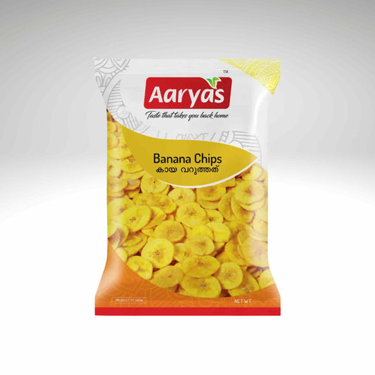 A bag of Aaryas Banana Chips on a light gray gradient background. The packaging features the red and white Aaryas logo at the top, a yellow banner with the product name, and a clear window showing the yellow banana chips inside.