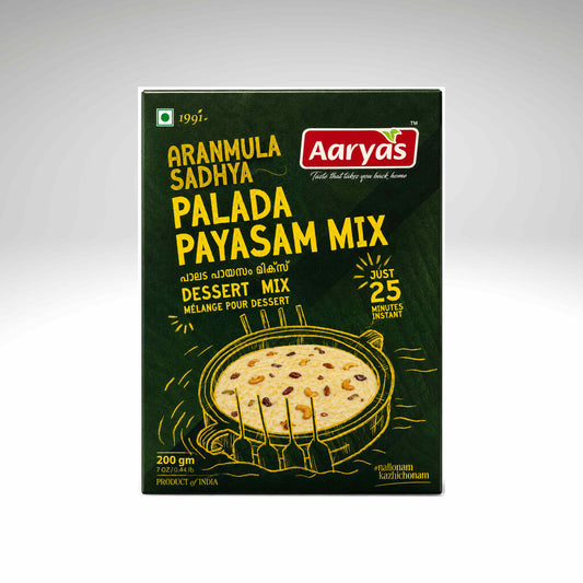 A box of Aaryas Aranmula Sadhya Palada Payasam Mix dessert mix, featuring a dark green background with yellow text and an illustration of the prepared dessert.