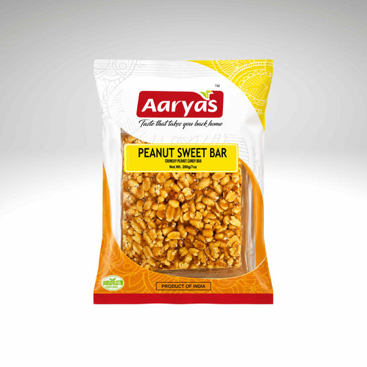 A bag of Aaryas Peanut Sweet Bar, featuring a white and orange packaging design with a clear window showing the golden-brown peanuts inside, set against a neutral gray background.
