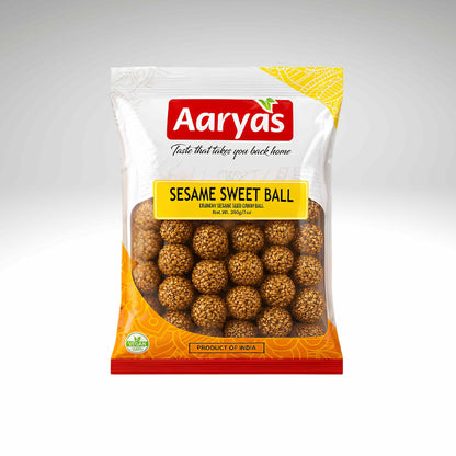 A package of Aaryas Sesame Sweet Ball, featuring a white and orange bag with a clear window showing the round, sesame-seed-coated sweets inside.