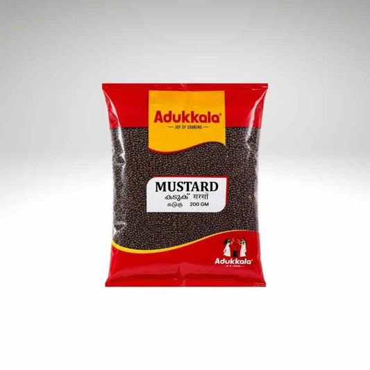 A 200g bag of Adukkala Mustard seeds, featuring a red and yellow packaging design with a clear window showing the dark brown mustard seeds inside, set against a light gray background.