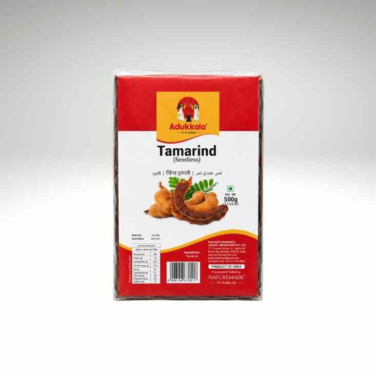 A 500g package of Adukala Tamarind, shown in its clear plastic wrapping against a neutral gray background.