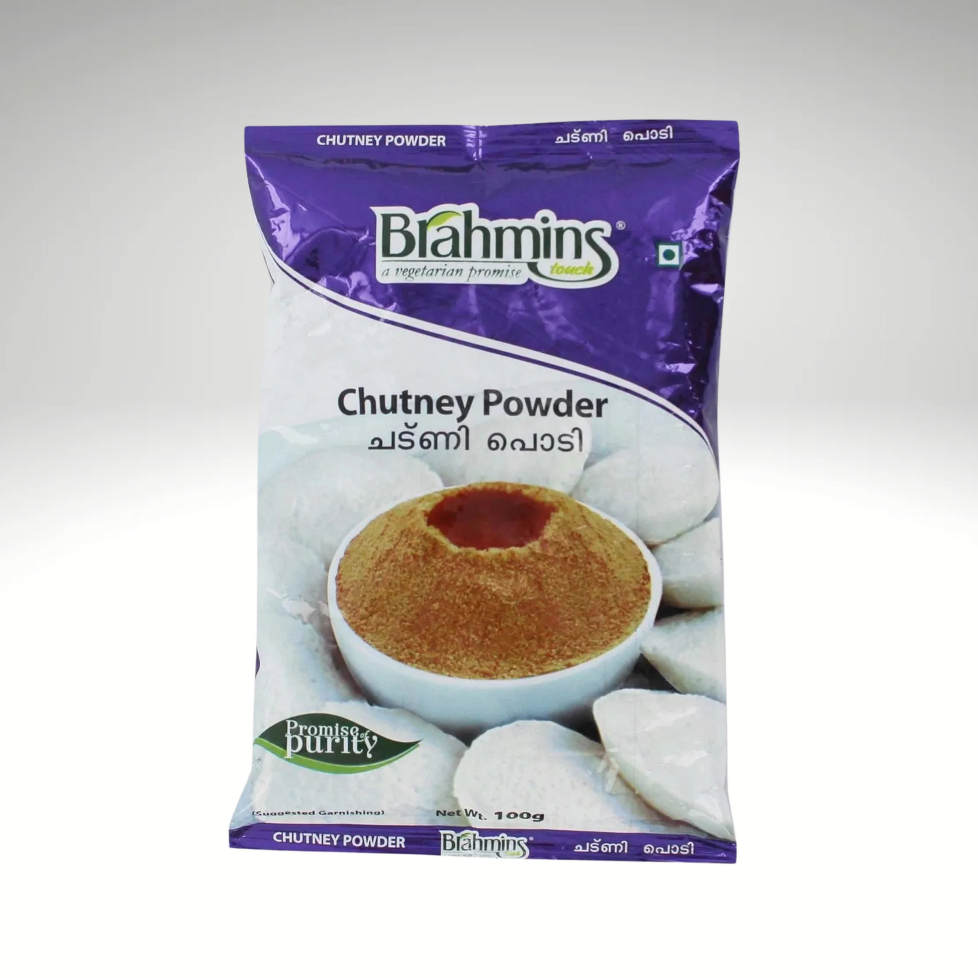 Image of a package of Brahmins Chutney Powder, featuring a colorful and eye-catching design with the product name prominently displayed. The packaging includes illustrations of the chutney powder alongside idli.