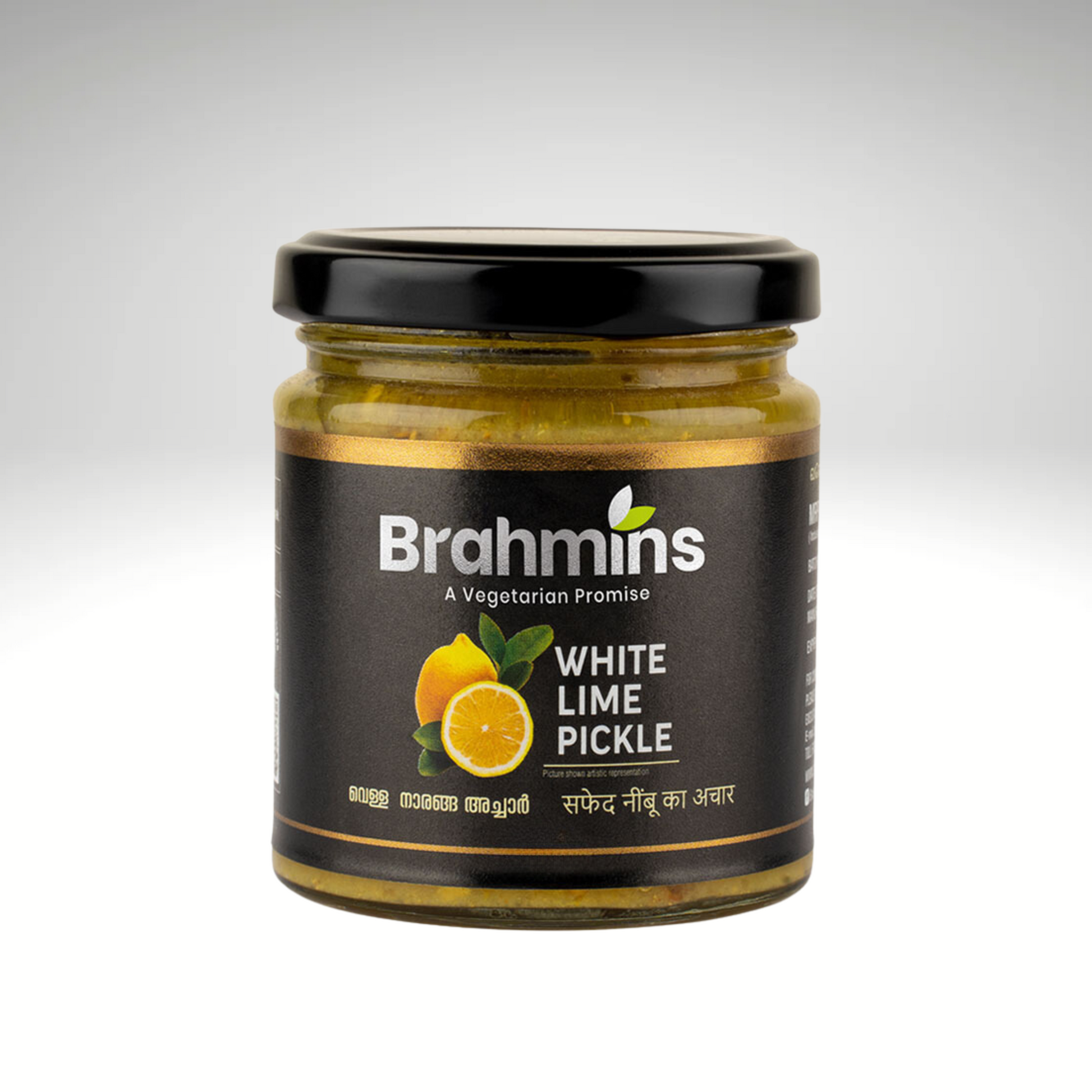 A jar of Brahmins White Lime Pickle, featuring bright yellow lime pieces placed next to whole limes and emphasizing its zesty flavour and vibrant color.