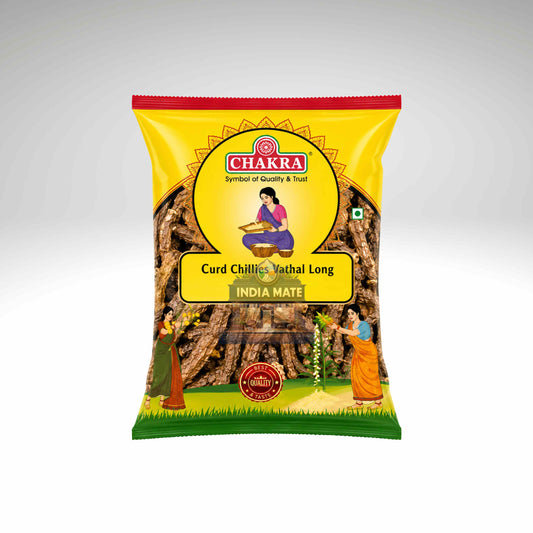 A bag of Chakra Curd Chilliis Mathal Long India Mate, featuring a bright yellow packaging with illustrations of a woman and trees, set against a neutral gray gradient background.