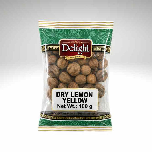 A 100g bag of Delight brand Dry Lemon Yellow nuts, shown in its green and gold patterned packaging with a clear window displaying the brown nuts inside, set against a neutral gray background.
