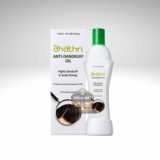 A bottle of dhāthri Anti-Dandruff Oil with a green cap next to its white packaging box, set against a light gray gradient background.