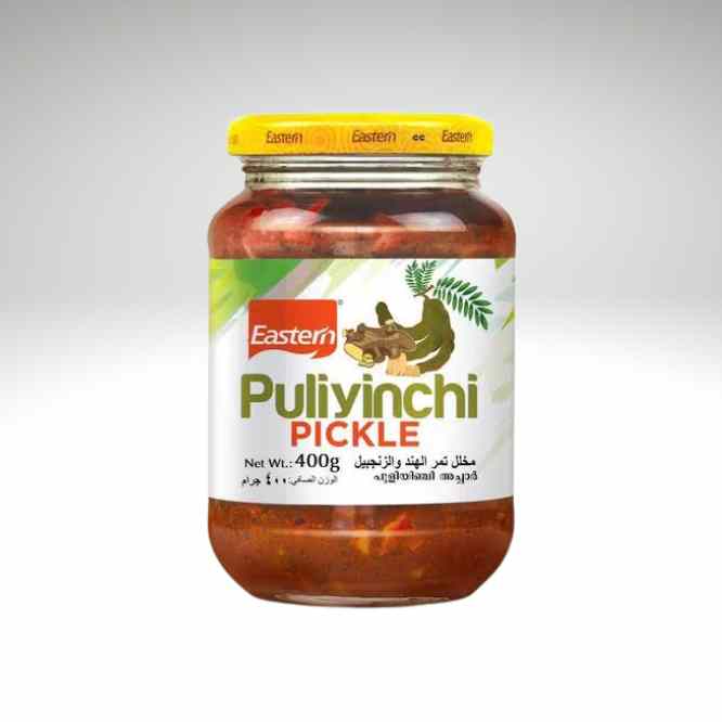 A glass jar of Eastern brand Puliyinchi Pickle with a yellow lid and a white label featuring green and red text, set against a light gray gradient background.