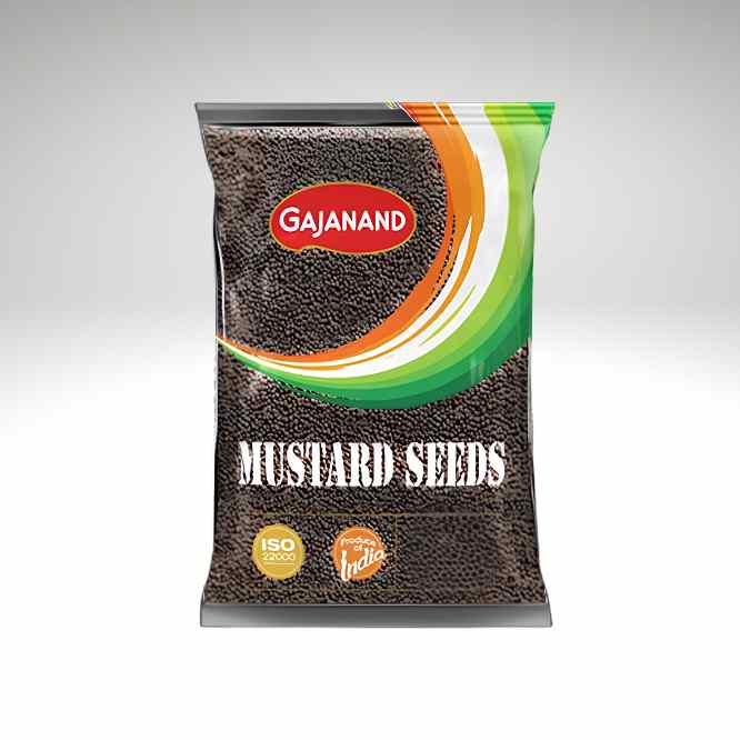 A bag of Gajanand mustard seeds on a light gray gradient background. The packaging is primarily dark brown to show the seeds inside, with a red oval logo containing the brand name 'GAJANAND' and curved green and orange stripes.