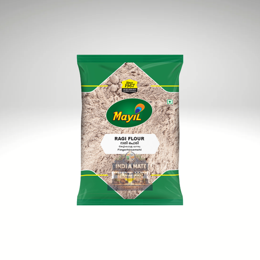 Mayil Ragi Flour, a pack of finely ground finger millet flour used in South Indian cooking for nutritious dishes. The product is in green and white packaging, featuring the Mayil brand logo and information about the ingredients, ideal for making rotis, dosas, and other healthy recipes.