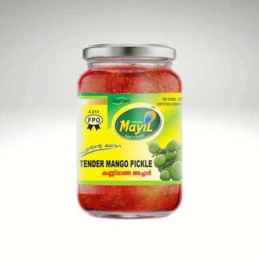 Mayil Tender Mango Pickle, a jar of authentic South Indian-style pickle made from fresh tender mangoes, preserved in a blend of spices and oil. The product is packaged in a vibrant green and yellow jar, showcasing the brand’s logo and ingredients on the label, perfect for adding a tangy, spicy flavour to meals.