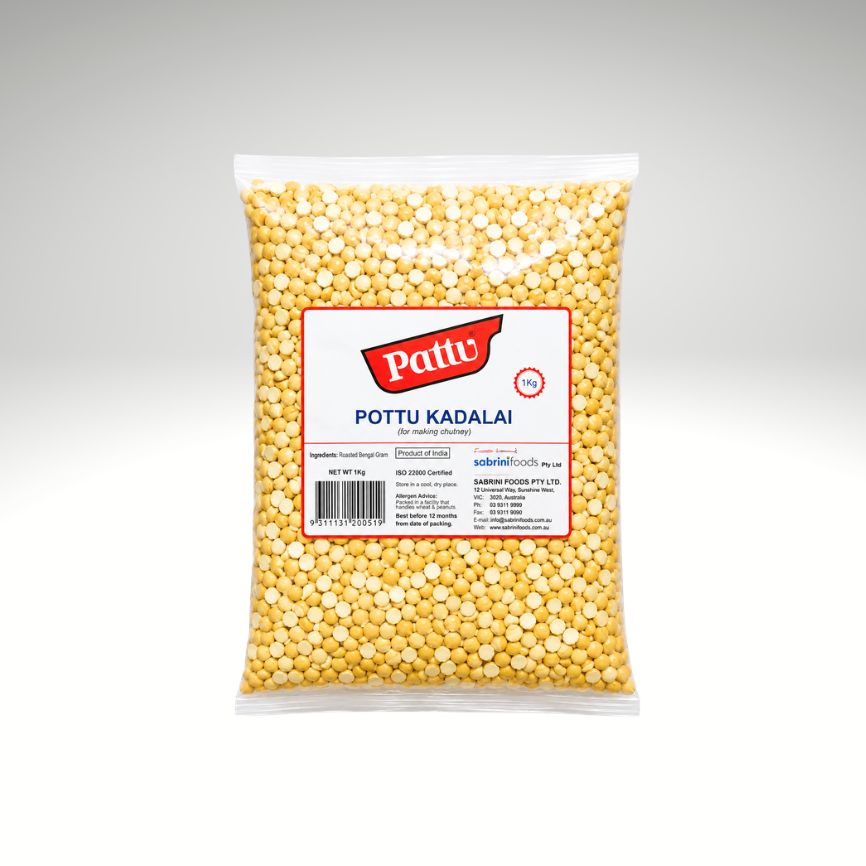 A clear plastic bag filled with yellow lentil pieces, featuring a white label with the red and blue 'Pattu' brand logo and the text 'POTTU KADALAI'.