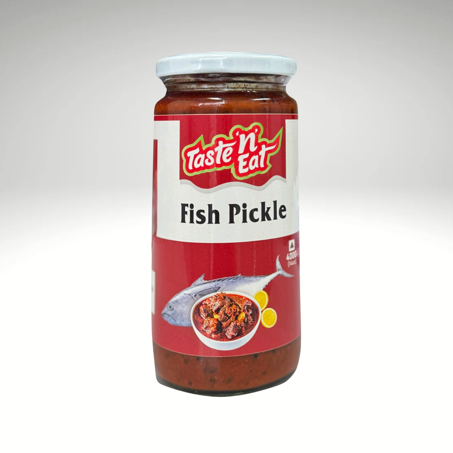 Taste N Eat Fish Pickle jar with a bold label featuring an image of spiced fish, highlighting the traditional Indian-style pickle with rich flavours of spices and oil.