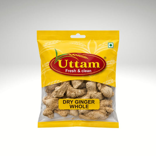 A package of Uttam brand Dry Ginger Whole, in a yellow bag with a clear window showing the dried ginger pieces inside, set against a neutral gray gradient background.
