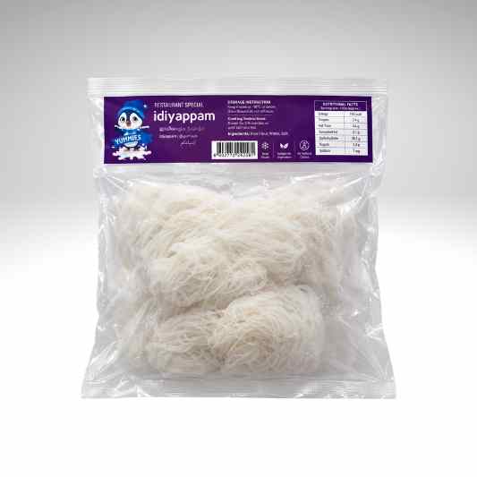 A clear plastic bag of idiyappam, showing the white thread-like noodles inside, with a purple label at the top containing the brand name 'Yummies Idiyappam'.